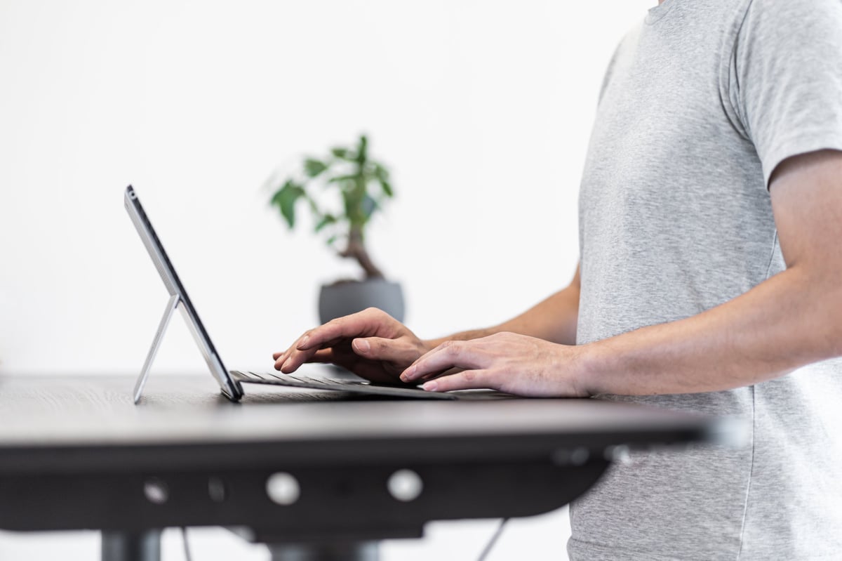 Asian man working at standing desk
