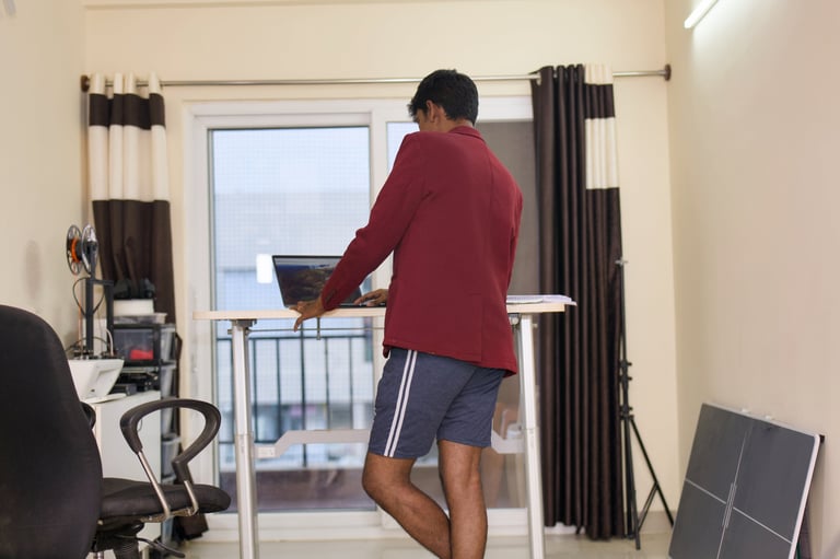 Young man working at standing desk